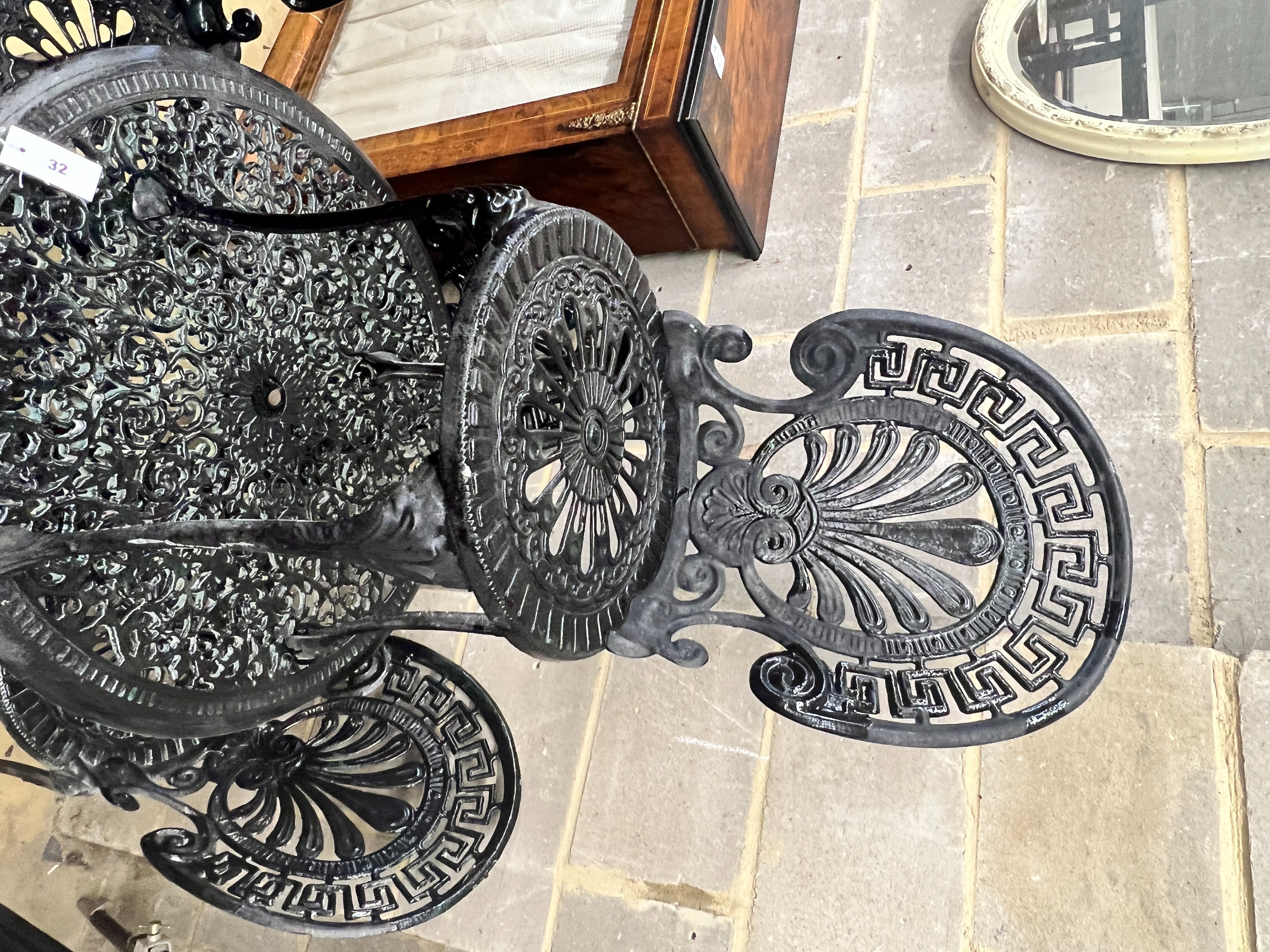 A Victorian style painted aluminium circular garden table, diameter 70cm, height 67cm and four chairs